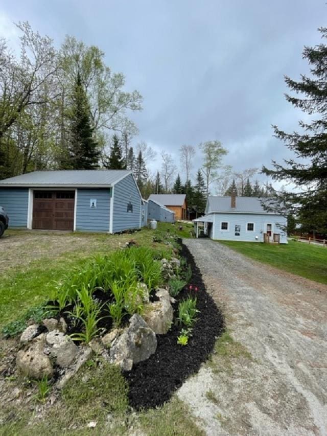 1295 Newark Pond Rd, Newark, VT 05871 - view of front of house featuring a garage and an outdoor structure