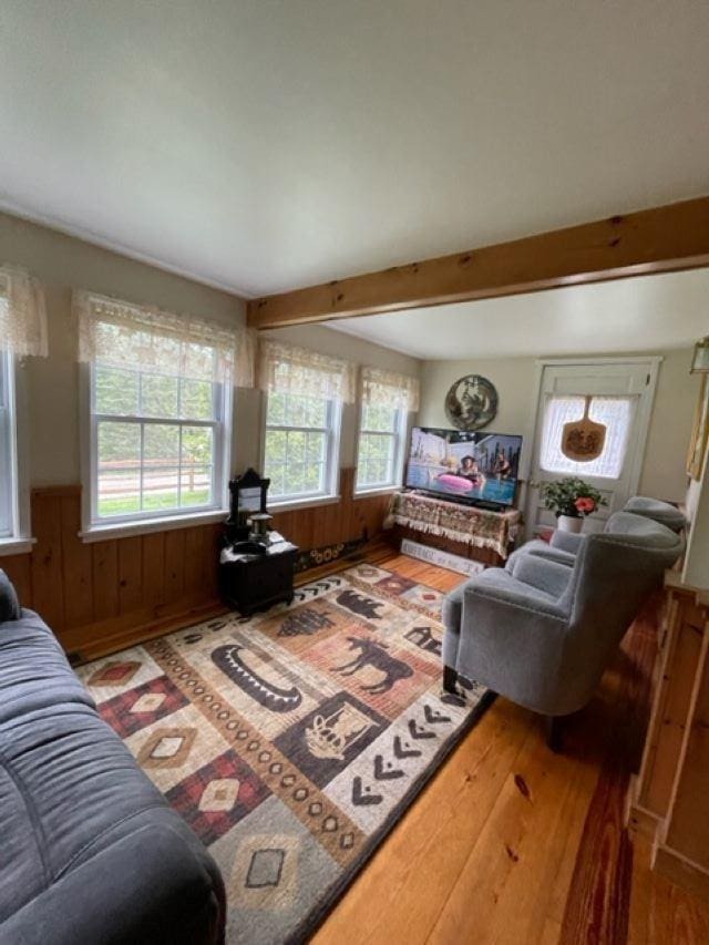1295 Newark Pond Rd, Newark, VT 05871 - living area with wood finished floors, wainscoting, beamed ceiling, and wood walls
