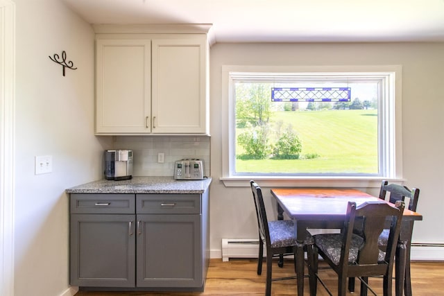 2147 Vt Route 111, Derby, VT 05829 - dining area featuring light wood-style floors, baseboards, and baseboard heating