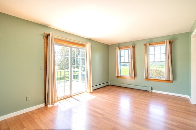 2147 Vt Route 111, Derby, VT 05829 - empty room with light wood-type flooring, baseboards, and a baseboard heating unit