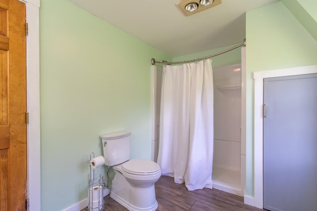 2147 Vt Route 111, Derby, VT 05829 - full bath featuring wood finished floors, curtained shower, toilet, and baseboards