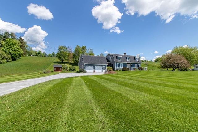 2147 Vt Route 111, Derby, VT 05829 - view of front facade featuring driveway, a garage, and a front yard
