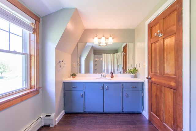 2147 Vt Route 111, Derby, VT 05829 - bathroom featuring a baseboard radiator, vanity, wood finished floors, and baseboards