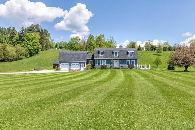2147 Vt Route 111, Derby, VT 05829 - view of front of house featuring a garage, a front yard, driveway, and a chimney