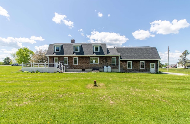 2147 Vt Route 111, Derby, VT 05829 - back of property featuring a yard, a deck, a chimney, a shingled roof, and brick siding