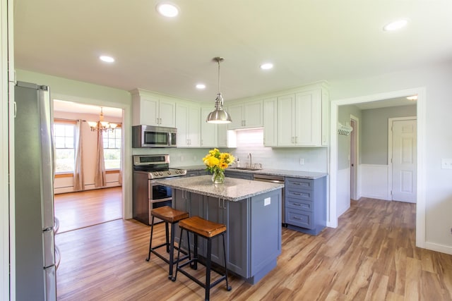 2147 Vt Route 111, Derby, VT 05829 - kitchen with appliances with stainless steel finishes, a sink, a chandelier, light wood-style floors, and recessed lighting