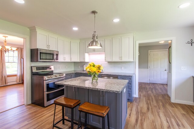 2147 Vt Route 111, Derby, VT 05829 - kitchen with appliances with stainless steel finishes, white cabinets, light wood finished floors, and recessed lighting