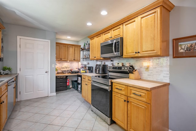 4 Palmer Ave, Plaistow, NH 03865 - kitchen with appliances with stainless steel finishes, backsplash, recessed lighting, light tile patterned floors, and wooden counters