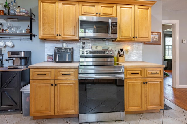 4 Palmer Ave, Plaistow, NH 03865 - kitchen with stainless steel appliances, decorative backsplash, and light tile patterned flooring
