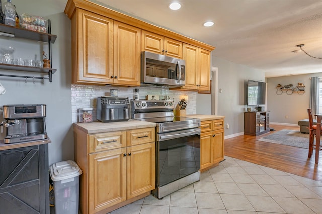 4 Palmer Ave, Plaistow, NH 03865 - kitchen with stainless steel appliances, decorative backsplash, recessed lighting, light tile patterned flooring, and baseboards