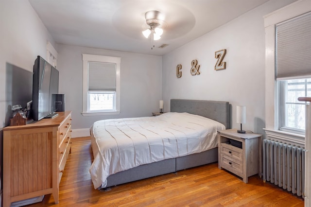 4 Palmer Ave, Plaistow, NH 03865 - bedroom featuring radiator heating unit, light wood finished floors, and a ceiling fan