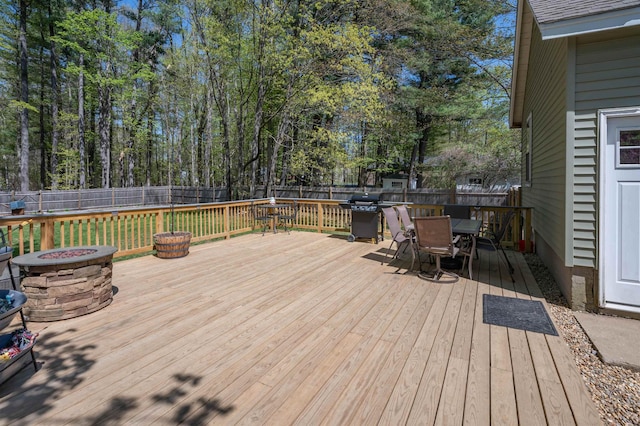 4 Palmer Ave, Plaistow, NH 03865 - deck featuring outdoor dining area, an outdoor fire pit, a fenced backyard, and a grill