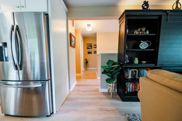 107 Artist Falls Rd, Conway, NH 03860 - kitchen with stainless steel refrigerator with ice dispenser, light wood-style floors, and baseboards