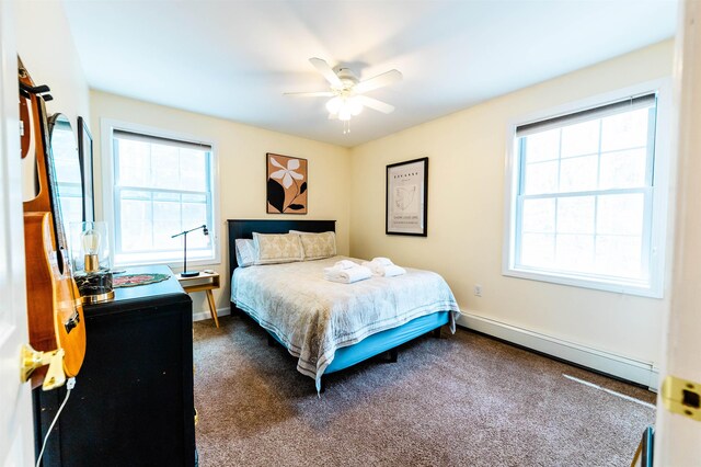 107 Artist Falls Rd, Conway, NH 03860 - bedroom with a baseboard radiator, dark colored carpet, baseboards, and a ceiling fan