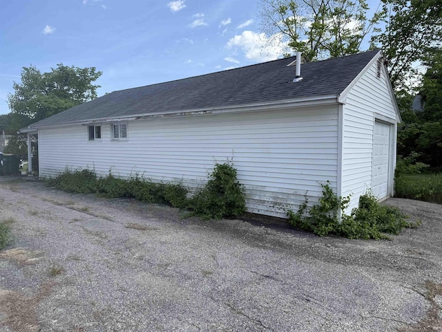154B Main St, Kingston, NH 03848 - view of side of home with a shingled roof and a garage