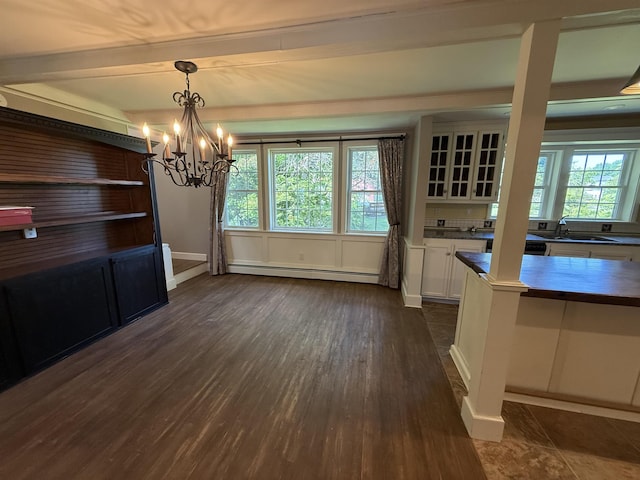 154B Main St, Kingston, NH 03848 - unfurnished dining area with a baseboard heating unit, dark wood-style flooring, a chandelier, a sink, and baseboards