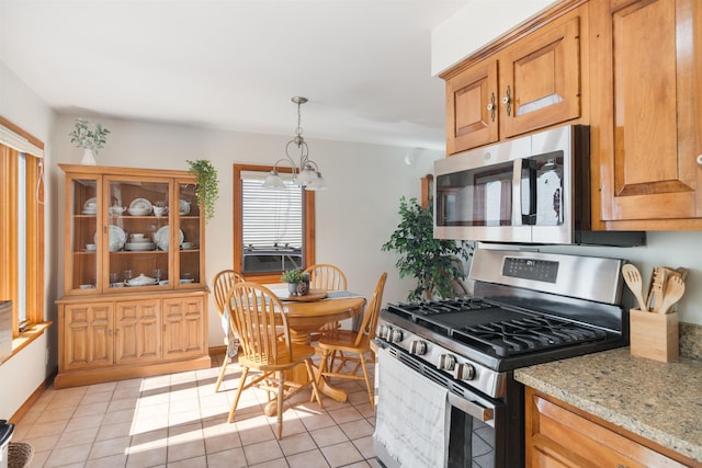 49 Morgan St, Burlington, VT 05408 - kitchen with appliances with stainless steel finishes, light tile patterned flooring, light stone countertops, and a chandelier
