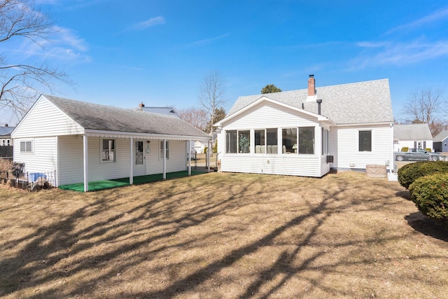 49 Morgan St, Burlington, VT 05408 - back of property with a sunroom, a shingled roof, and a chimney