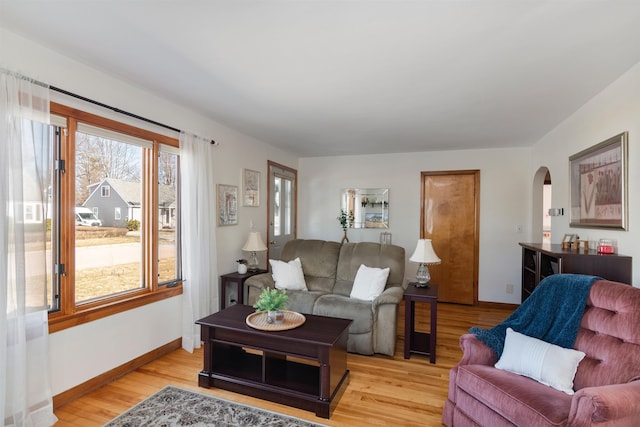 49 Morgan St, Burlington, VT 05408 - living room with arched walkways, light wood-type flooring, and baseboards