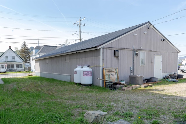 18 State St, Northumberland, NH 03582 - back of property with central AC unit, a yard, and an outbuilding