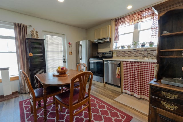 18 State St, Northumberland, NH 03582 - kitchen with stainless steel appliances, under cabinet range hood, a sink, light wood finished floors, and light countertops
