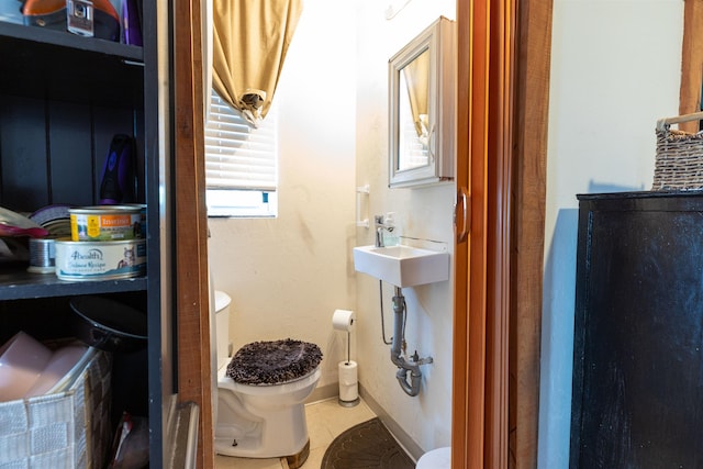 18 State St, Northumberland, NH 03582 - bathroom with toilet, baseboards, tile patterned floors, and a sink