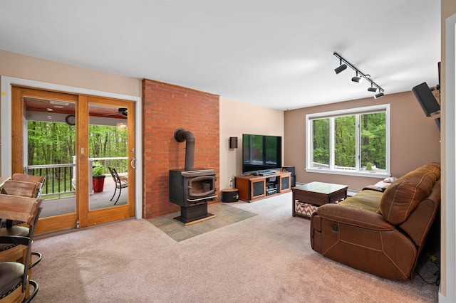 11 Sledding Hill Ln, Lee, NH 03861 - carpeted living room featuring rail lighting and a wood stove