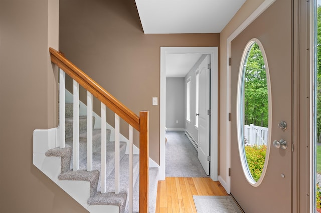 11 Sledding Hill Ln, Lee, NH 03861 - foyer with light wood finished floors, stairway, baseboards, and baseboard heating