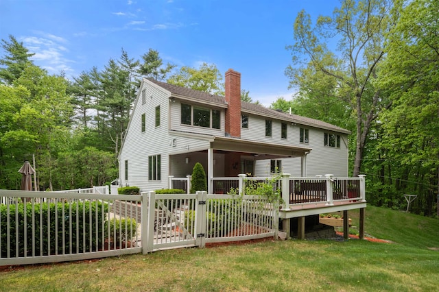 11 Sledding Hill Ln, Lee, NH 03861 - back of house featuring a chimney, a deck, and a lawn