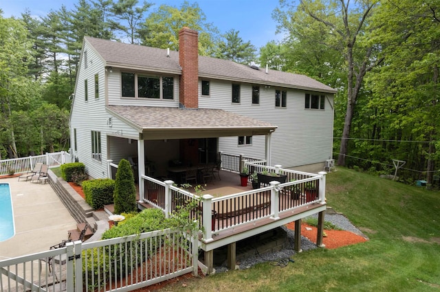 11 Sledding Hill Ln, Lee, NH 03861 - back of property with a chimney, a deck, roof with shingles, and outdoor dining space