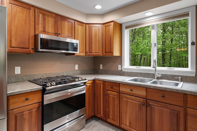 11 Sledding Hill Ln, Lee, NH 03861 - kitchen with stainless steel appliances, a sink, and brown cabinets