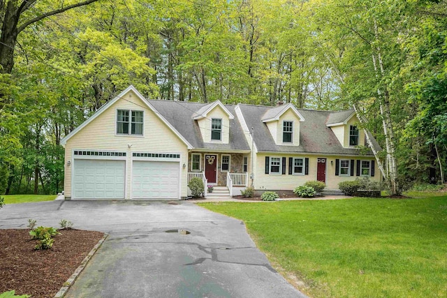 185 Whitford St, Manchester, NH 03104 - cape cod-style house featuring asphalt driveway, a front yard, a garage, view of wooded area, and a porch
