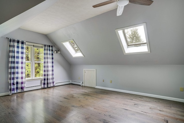 185 Whitford St, Manchester, NH 03104 - bonus room with a skylight, vaulted ceiling, wood finished floors, baseboards, and a ceiling fan