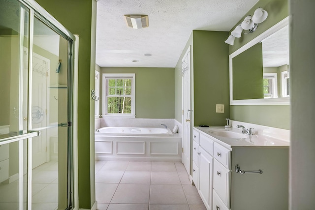 185 Whitford St, Manchester, NH 03104 - bathroom with vanity, a bath, a stall shower, tile patterned floors, and a textured ceiling