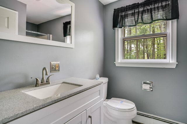 185 Whitford St, Manchester, NH 03104 - bathroom featuring a baseboard heating unit, toilet, and vanity