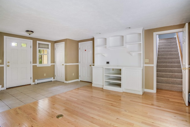 185 Whitford St, Manchester, NH 03104 - foyer entrance with a baseboard heating unit, stairway, light wood finished floors, and baseboards