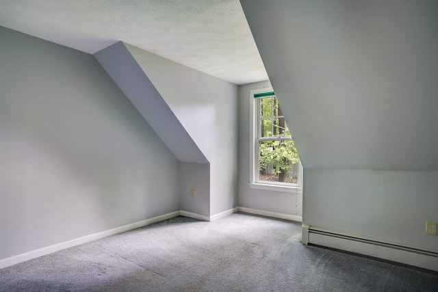 185 Whitford St, Manchester, NH 03104 - additional living space featuring a baseboard heating unit, carpet, baseboards, lofted ceiling, and a textured ceiling