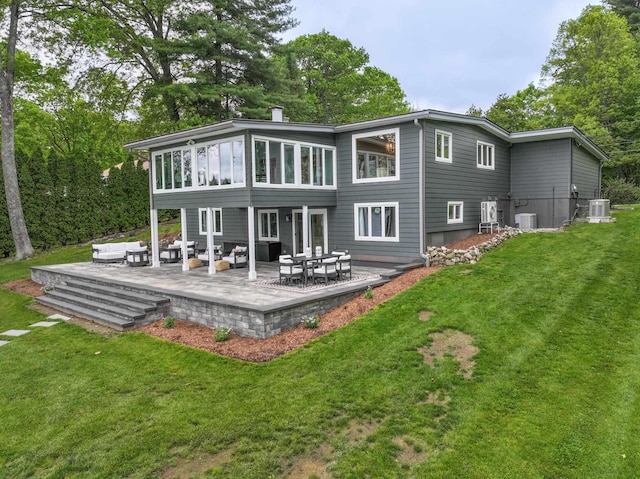 28 Woodvue Rd, Windham, NH 03087 - back of property with an outdoor hangout area, central AC, and a lawn