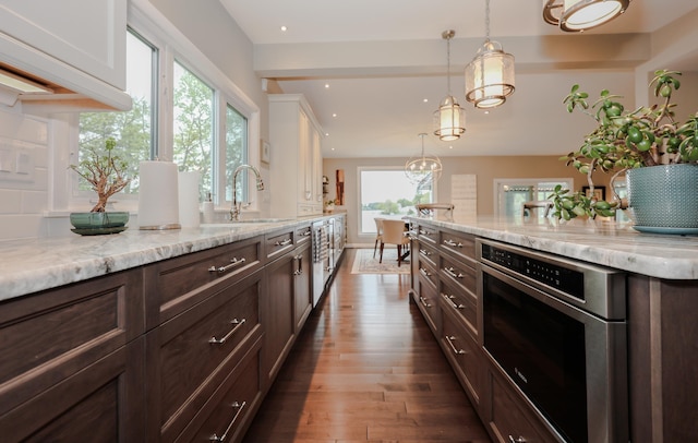 28 Woodvue Rd, Windham, NH 03087 - kitchen featuring dark wood finished floors, dark brown cabinets, a sink, pendant lighting, and light stone countertops