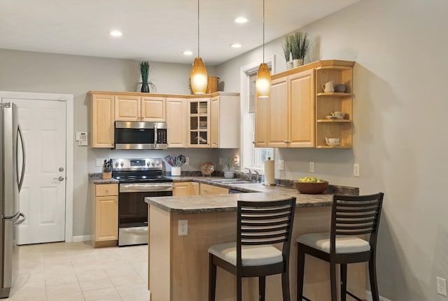 9 Swenson Rd, Bedford, NH 03110 - kitchen with appliances with stainless steel finishes, light brown cabinetry, a peninsula, dark countertops, and a breakfast bar