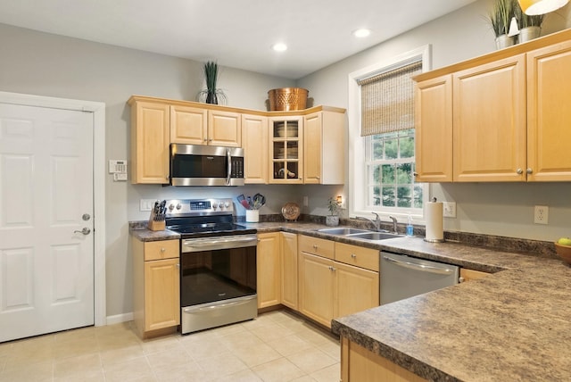 9 Swenson Rd, Bedford, NH 03110 - kitchen with stainless steel appliances, a sink, light brown cabinetry, dark countertops, and glass insert cabinets