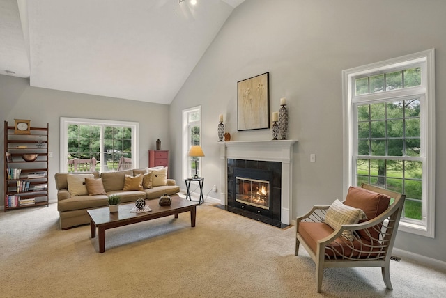9 Swenson Rd, Bedford, NH 03110 - living area with carpet flooring, a tiled fireplace, high vaulted ceiling, and baseboards