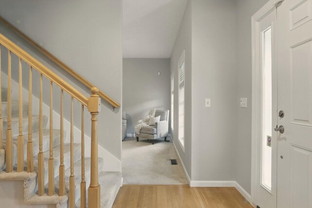 9 Swenson Rd, Bedford, NH 03110 - foyer entrance featuring wood finished floors, stairway, and baseboards
