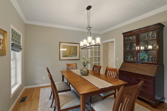9 Swenson Rd, Bedford, NH 03110 - dining room with light wood-style floors, crown molding, a chandelier, and baseboards