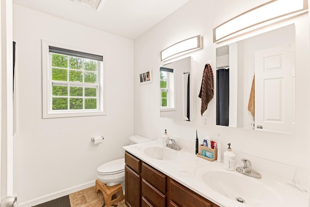 1191 Beech Ridge Rd, North Berwick, ME 03906 - bathroom featuring baseboards, double vanity, and toilet