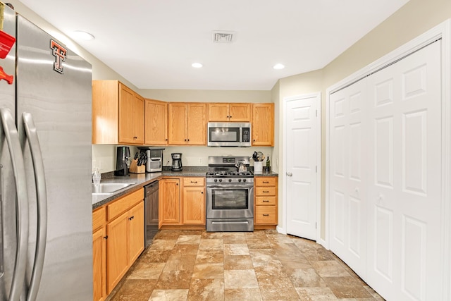 1191 Beech Ridge Rd, North Berwick, ME 03906 - kitchen with stainless steel appliances, dark countertops, stone finish floors, a sink, and recessed lighting