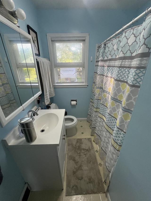 14 Brierwood Ln, Burlington, VT 05408 - full bath with vanity, toilet, tile patterned flooring, a shower with shower curtain, and baseboards