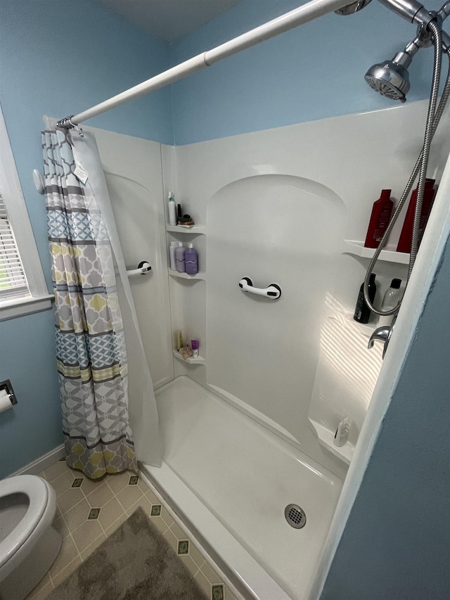 14 Brierwood Ln, Burlington, VT 05408 - bathroom with a shower stall, tile patterned flooring, and toilet