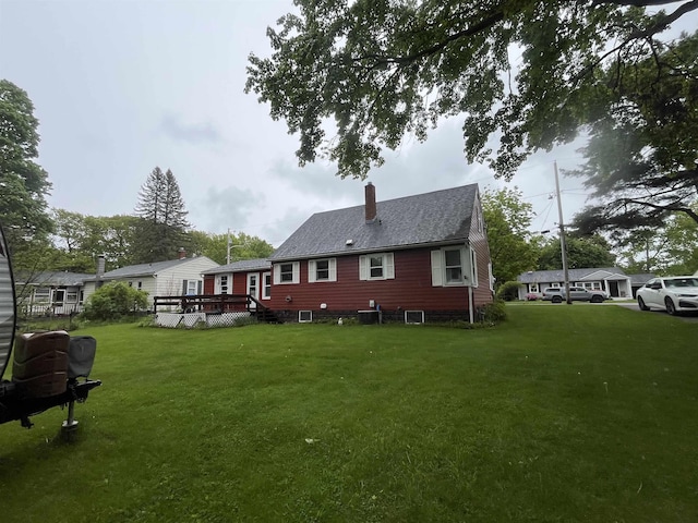 14 Brierwood Ln, Burlington, VT 05408 - rear view of property featuring a chimney, a deck, a yard, and a shingled roof