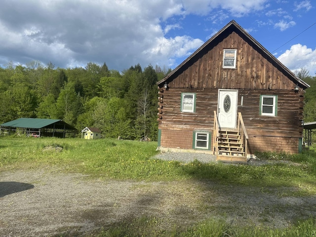 3342 E Hill Rd, Wolcott, VT 05680 - log cabin featuring entry steps, log siding, and a forest view